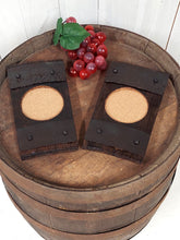 Load image into Gallery viewer, Top view of two rustic barrel stave wine glass coasters  with cork-bottomed glasses indent.
