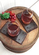 Load image into Gallery viewer, Top view of two rustic barrel stave wine glass coasters displaying stemless glasses of wine.
