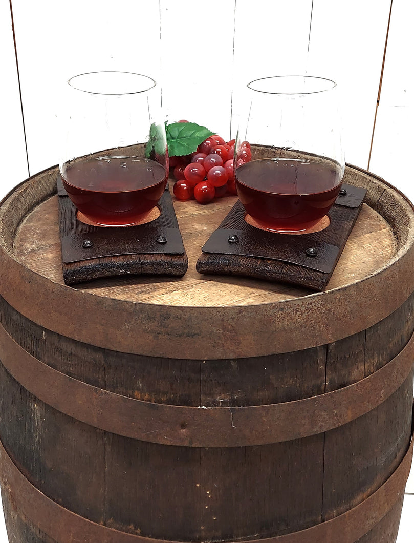 Two rustic barrel stave wine glass coasters displaying stemless glasses of wine.