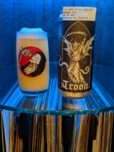 Load image into Gallery viewer, Open door view of whiskey barrel displaying customer&#39;s glass and can of Troon beer. Illuminated by blue hue light and showing record albums below round glass shelf.
