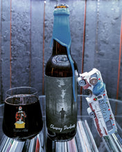 Load image into Gallery viewer, Open door view of whiskey barrel displaying customer&#39;s Bottle and glass of Timber Ale&#39;s Charging Darkness craft beer.  Illuminated by white light and showing record albums below round glass.
