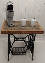 Load image into Gallery viewer, A barnboard tabletop affixed to a Singer sewing machine stand.  Displays a Keurig coffee maker and two coffee cups.
